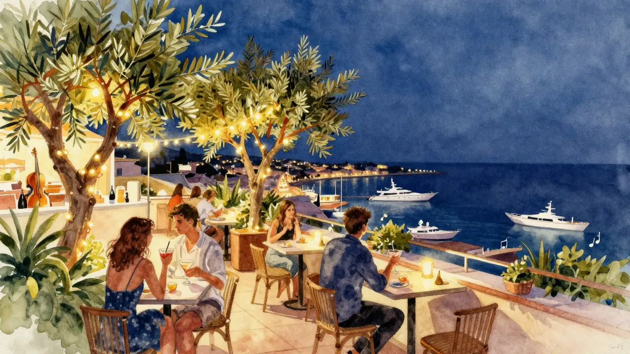Rooftop bar at night with string lights, olive trees, and glowing yachts on the harbor below.