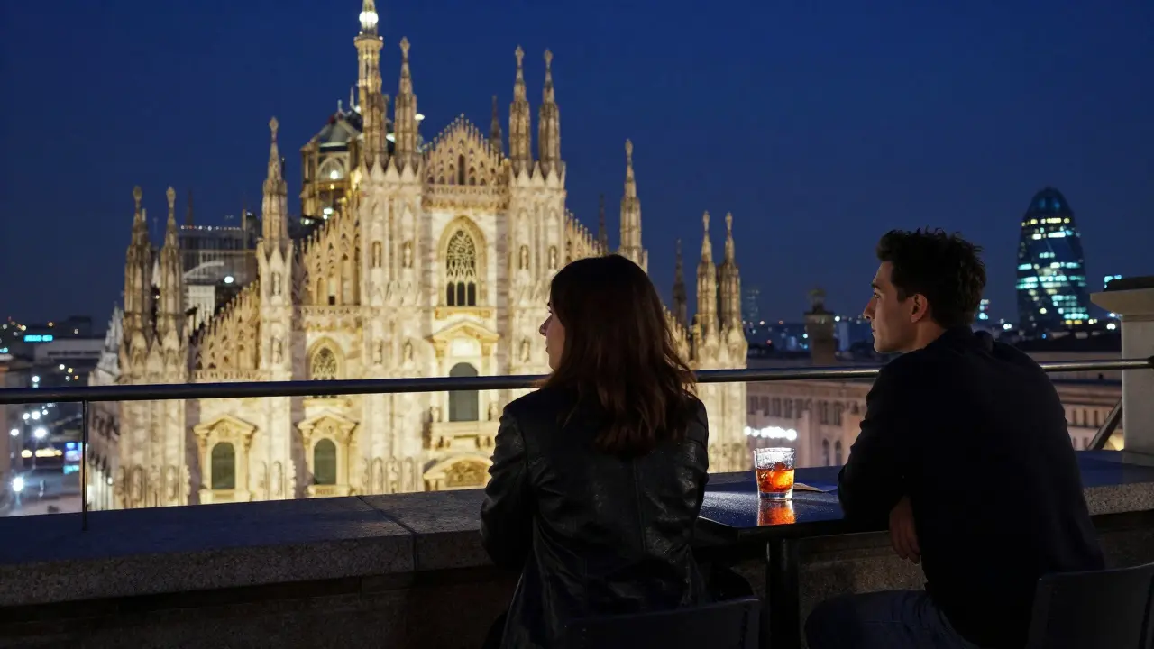 Two people sitting on a rooftop terrace overlooking Milan's illuminated skyline at night.